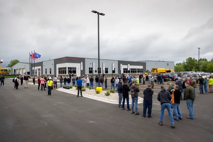 An excited crowd of employees and guests gathers in front of the plant in Chilton, Wisconsin, in preparation for the Aebi Schmidt North America grand opening event.