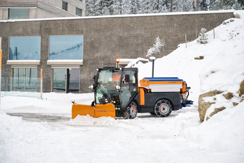 La Schmidt Flexigo 150 limpia nieve y esparce fundente en invierno y se utiliza en periodos sin nieve ni hielo para barrer, baldear, fregar, regar, segar, compactar y transportar.