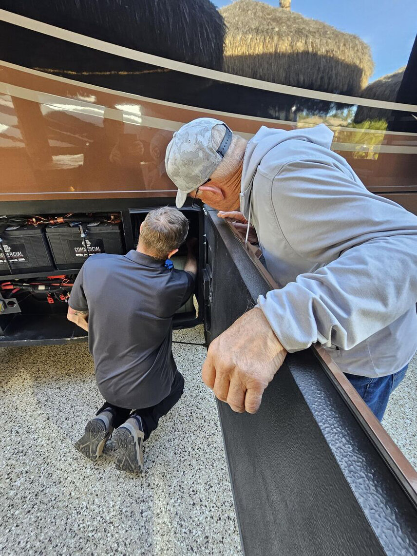 A technician shows a customer the benefits of our easy-to-access service bay at the Spartan Training Academy in Charlotte, Michigan.